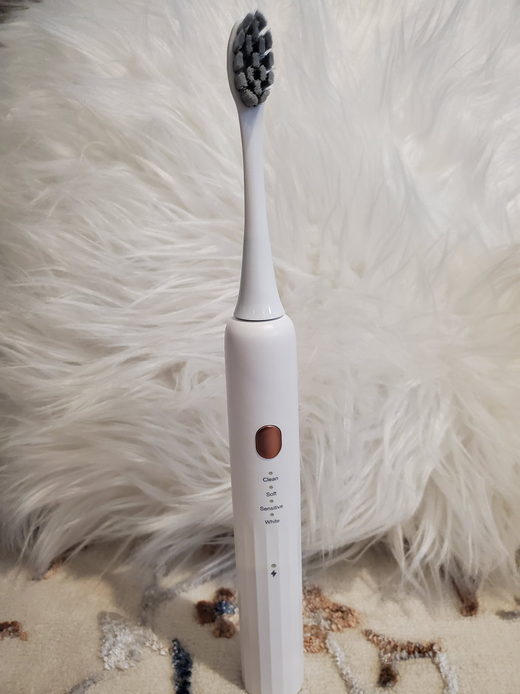 Electric toothbrush on a fluffy white surface