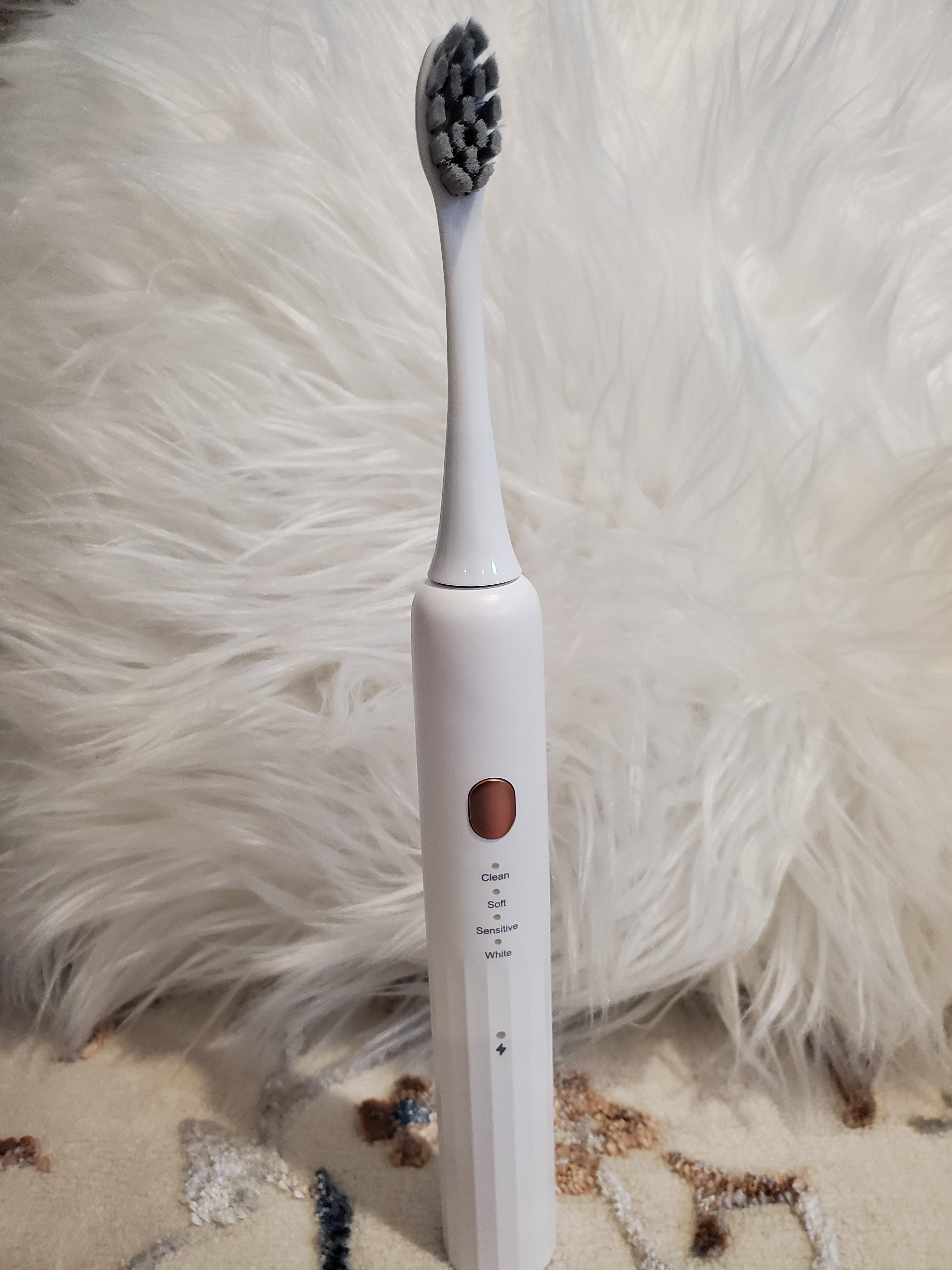 Electric toothbrush on a fluffy white surface
