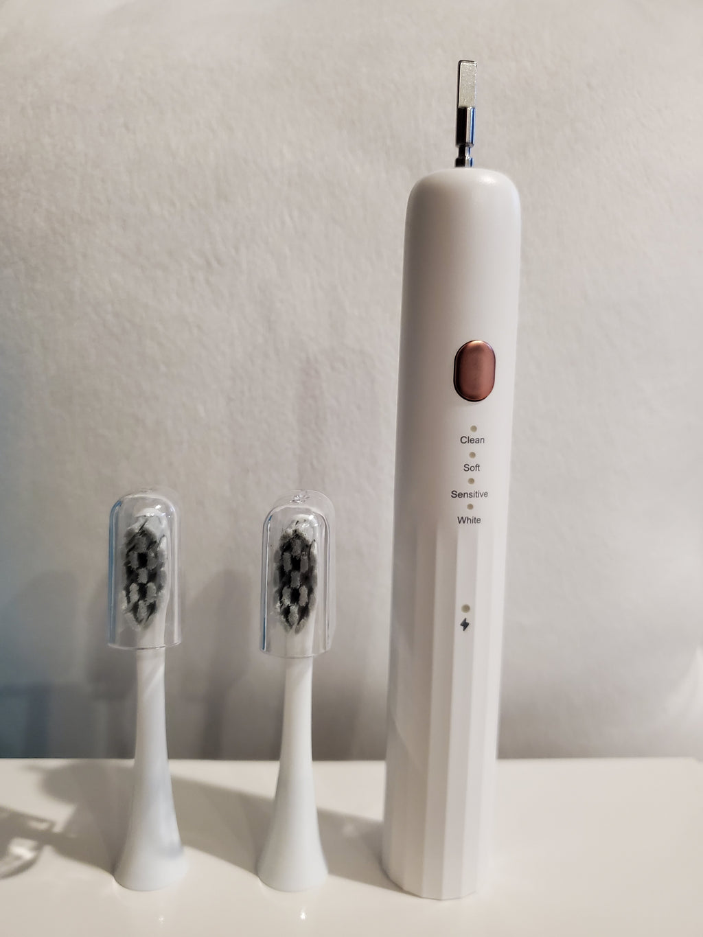 Electric toothbrush with multiple heads on a white background