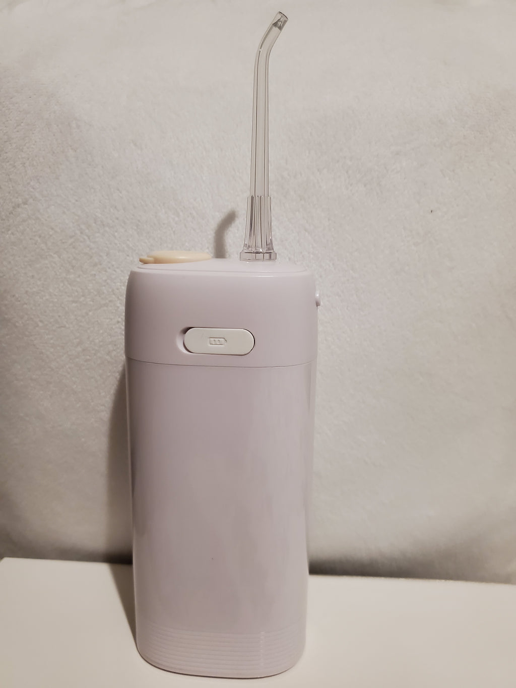 Portable handheld device with a nozzle 