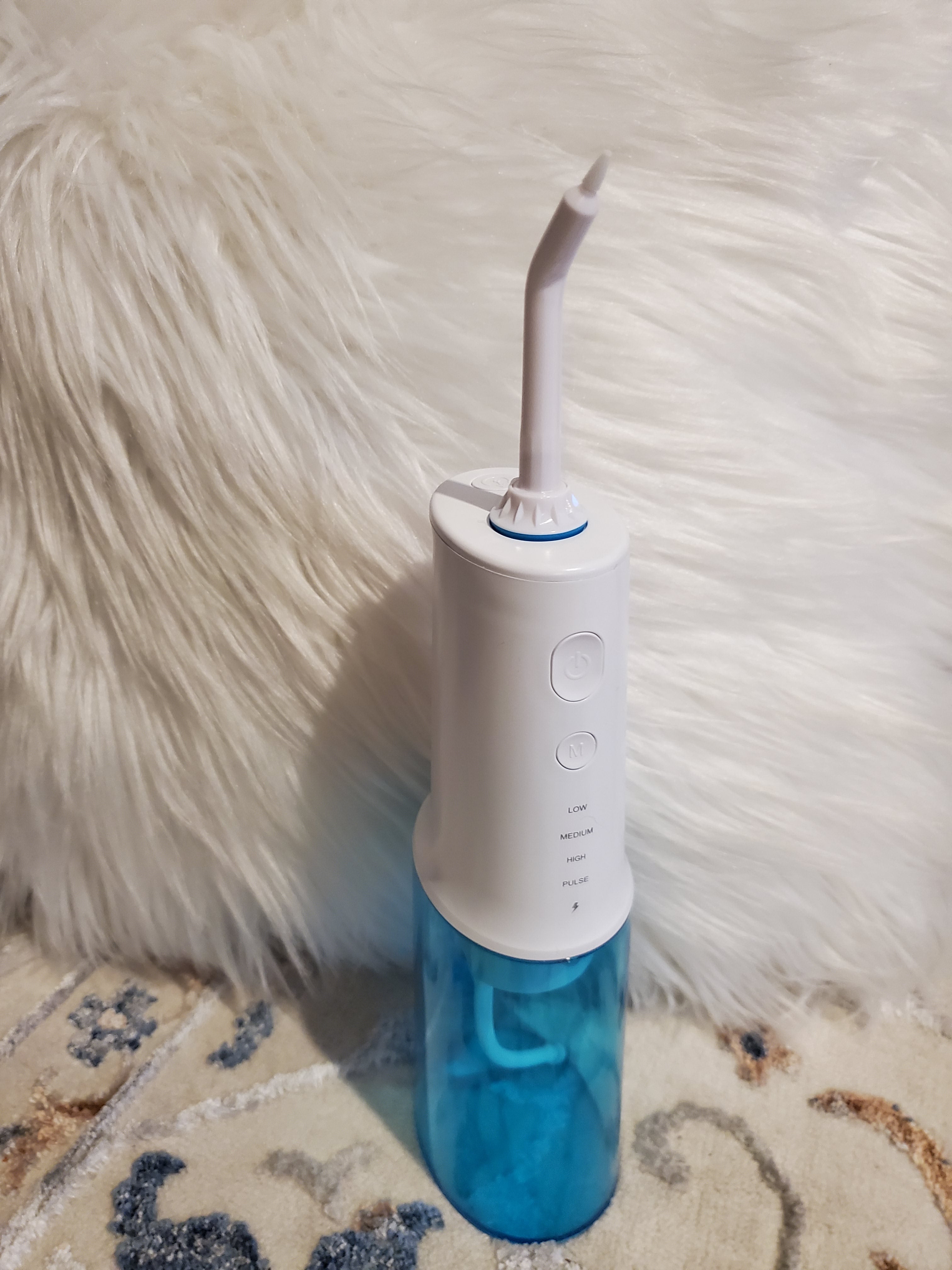 White and blue dental flosser 