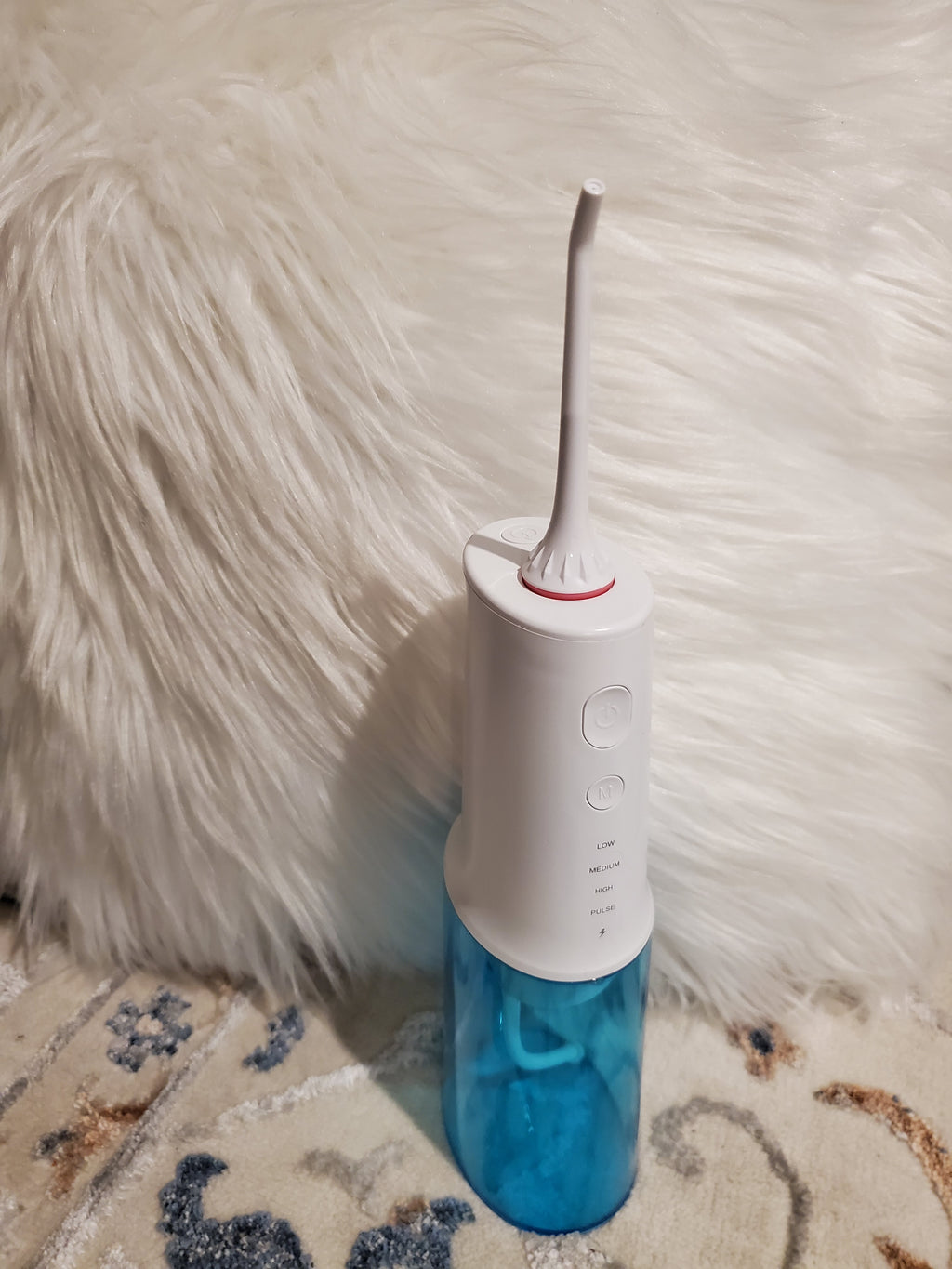 White and blue dental flosser
